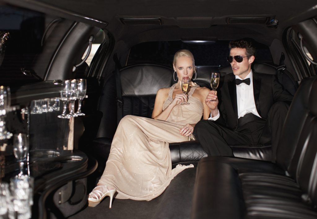 Couple drinking champagne in limo