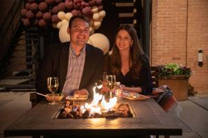 Kevin & Yerenia Smith enjoy dinner by the fire in Napa Valley